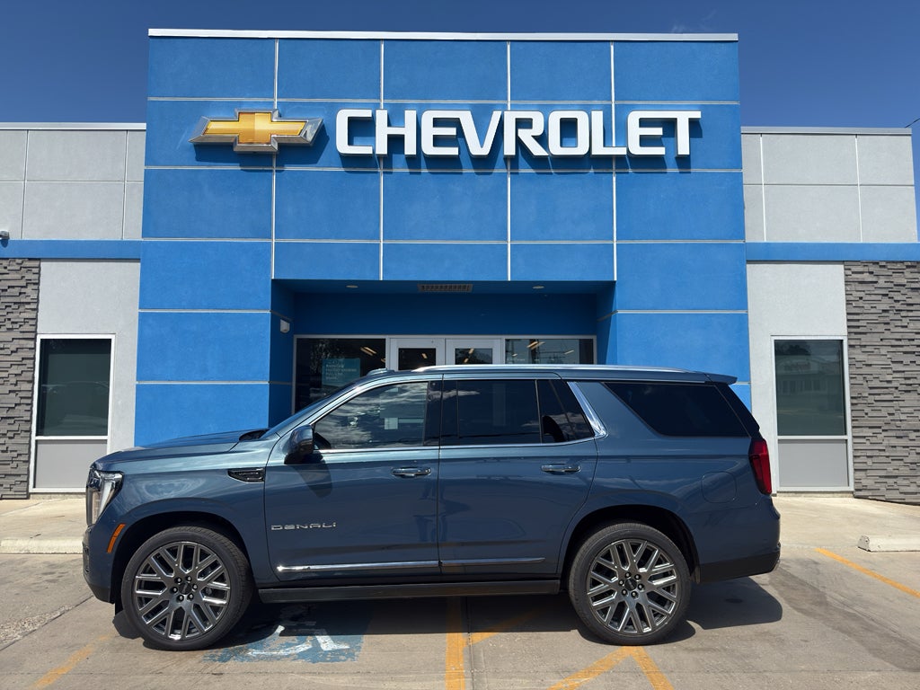 2026 GMC Yukon Denali Ultimate in Downpour Metallic — front three-quarter view